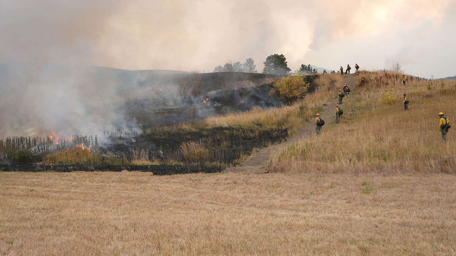 Firefighting crews worked overnight Thursday on back burning operations to battle the Elk Fire in northern Wyoming. Some of those including drones dropping incendiary devices in hard-to-get-to places and created an eerie glow in spots overnight.