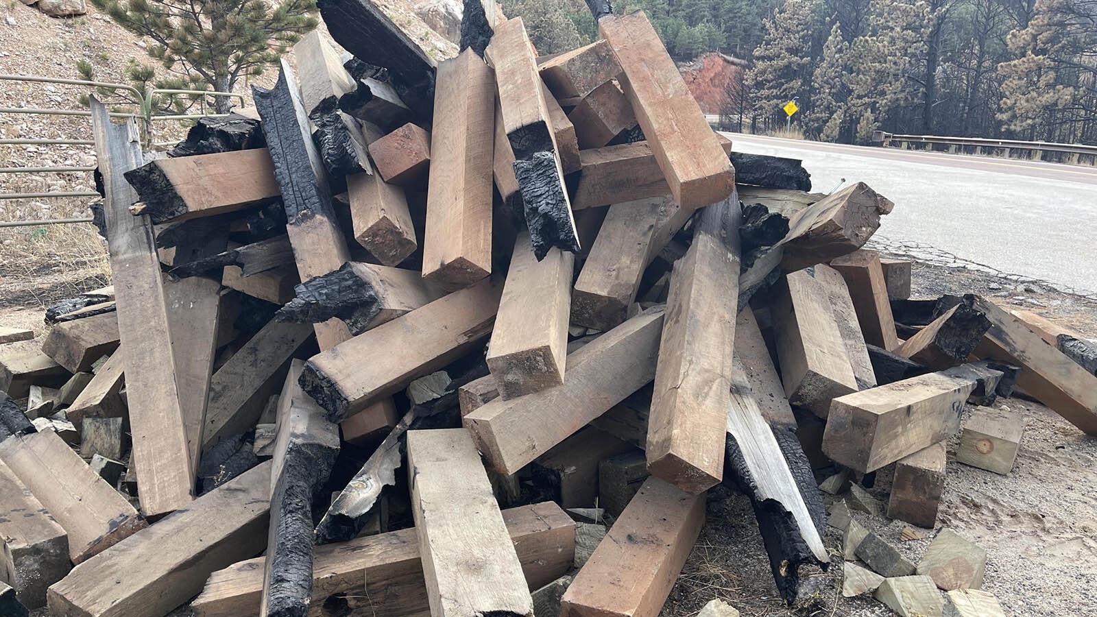 A pile of damaged guardrail posts from along Highway 14 in the Elk Fire burn area.