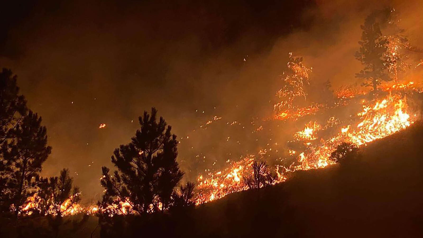 Firefighting crews worked overnight Thursday on back burning operations to battle the Elk Fire in northern Wyoming. Some of those including drones dropping incendiary devices in hard-to-get-to places and created an eerie glow in spots overnight.