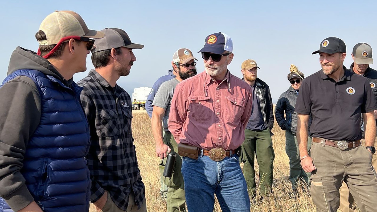 Gov. Mark Gord visits with some of the more than 900 people assigned to the incident management team to fight the Elk Fire on Sunday.