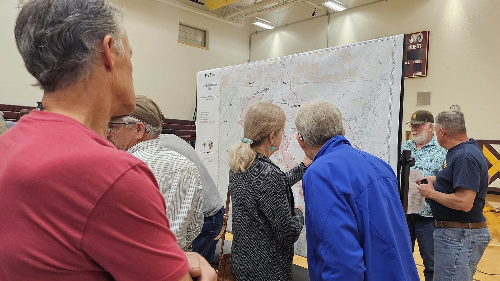 Residents check the Elk Fire map after a community access meeting held in Big Horn Wednesday night.