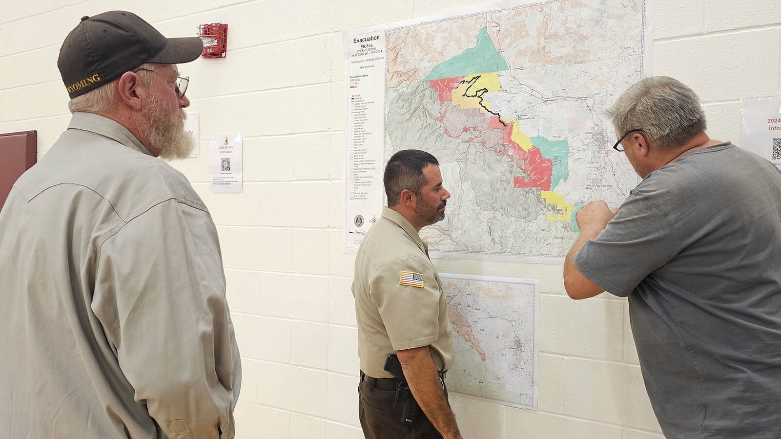 Sheridan County Sheriff Levi Dominguez, center, talks with residents of story and Big Horn about efforts to contain the Elk Fire.