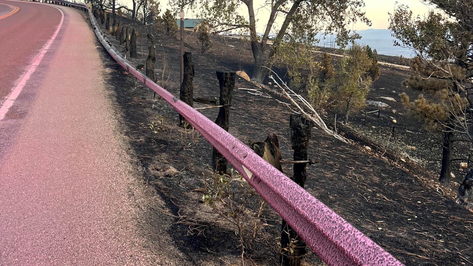 The elk fire has burned through the posts holding this section of guardrail along Highway 14, and also discolored and warped the steel guardrail.