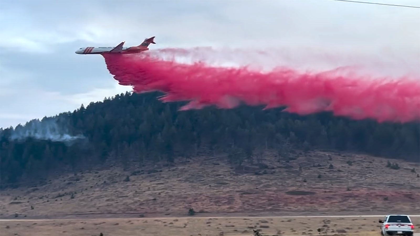 A large jet tanker drops a load of retardant on the Elk Fire.