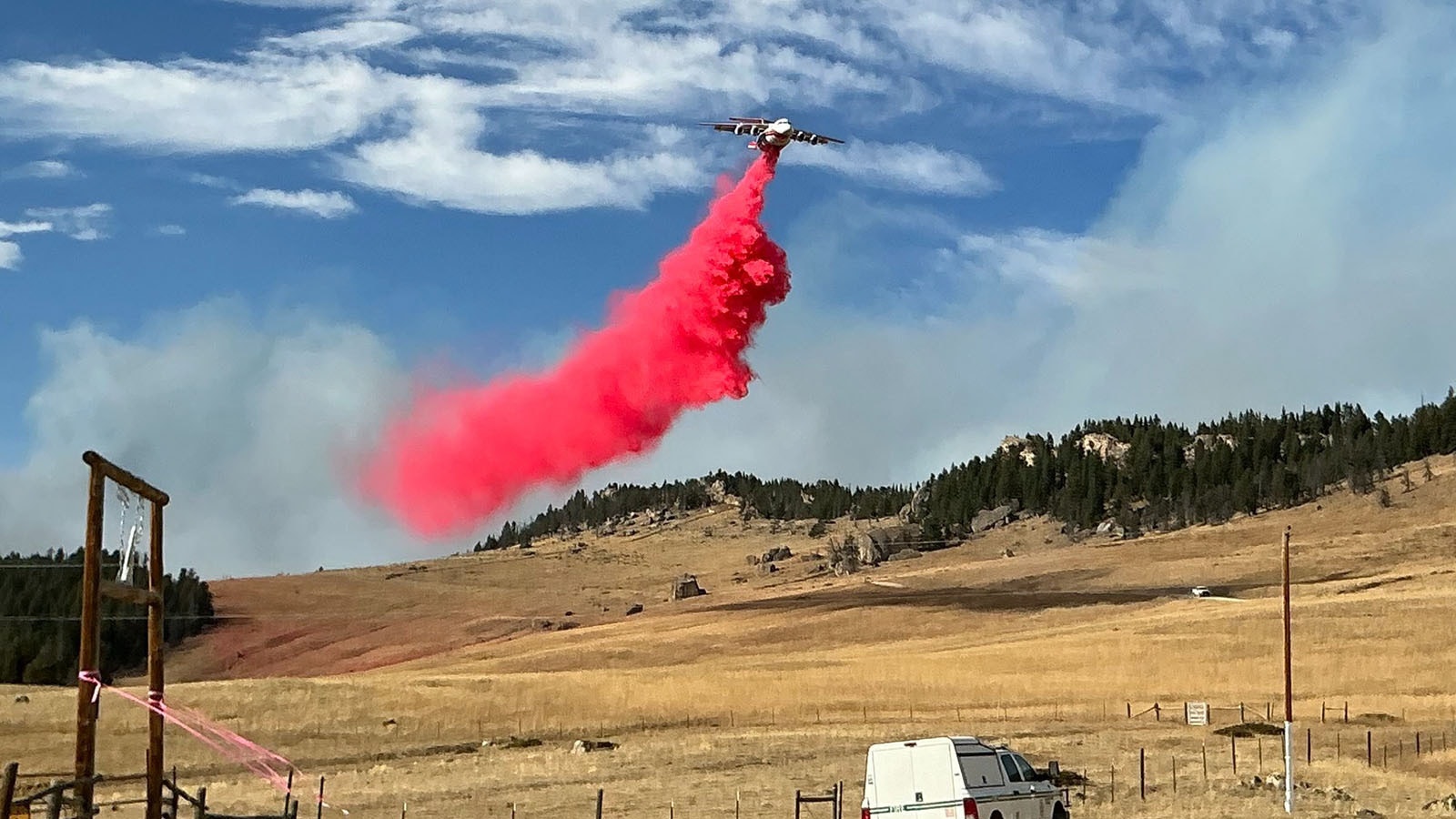 Aircraft continue to drop huge loads of fire retardant slurry around the Elk Fire to try and slow or halt it's spread and help establish fire lines.