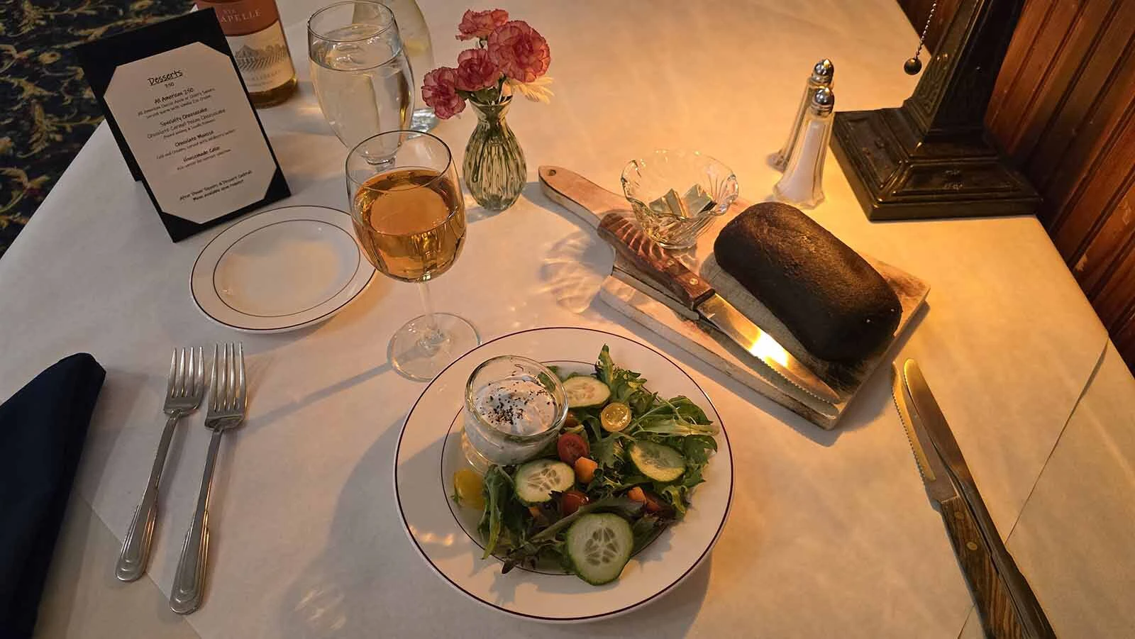 Fresh-baked bread and a spring mix salad round out dinner at Elk Mountain Motel.