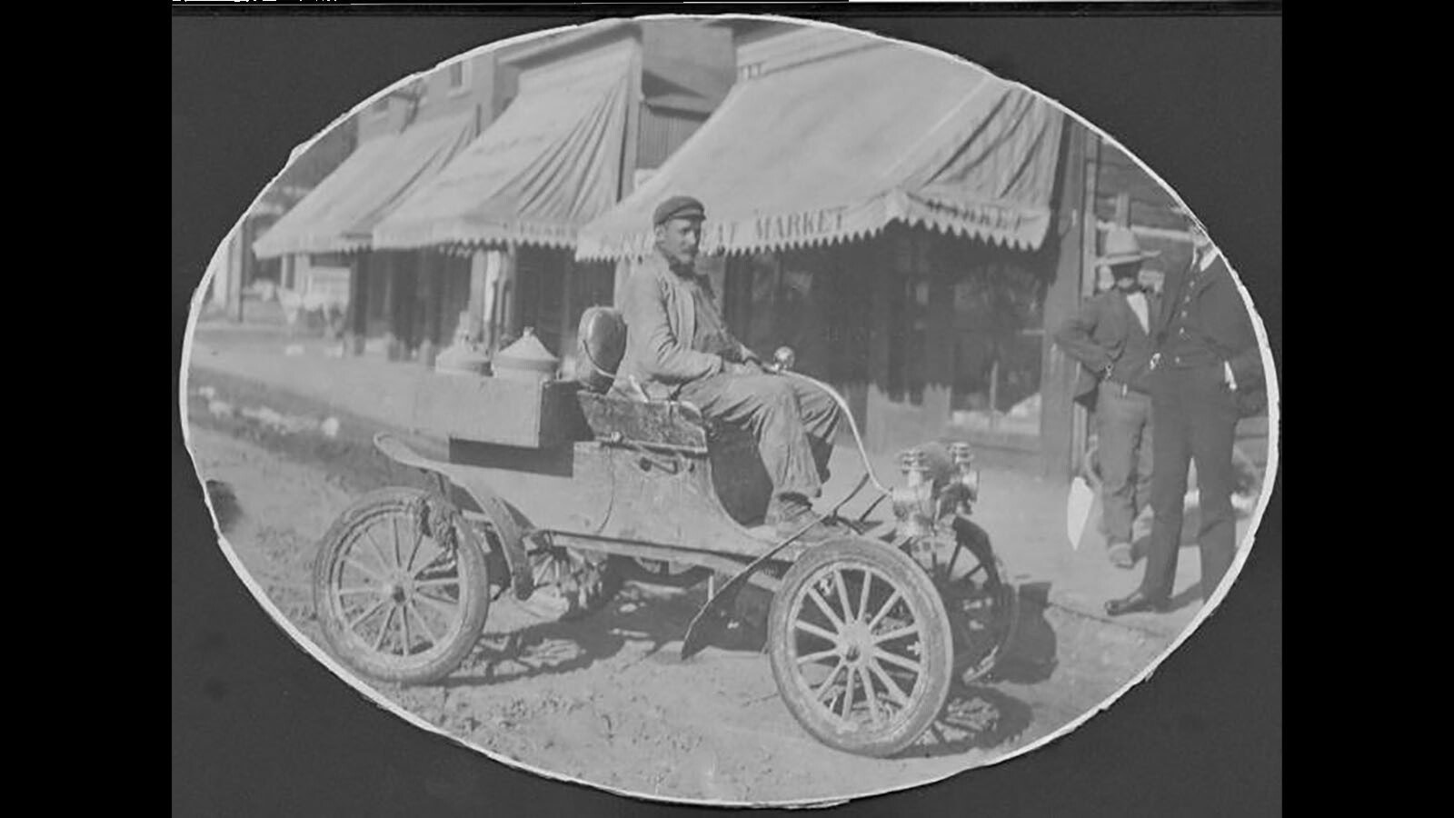 Elmer Lovejoy in 1901 Oldsmobile in front of Lovejoy Novelty store. Although Lovejoy's own invention made history in 1898, he was eager to try out those from other innovators and eventually became a dealer of Franklin and Studebaker autos.