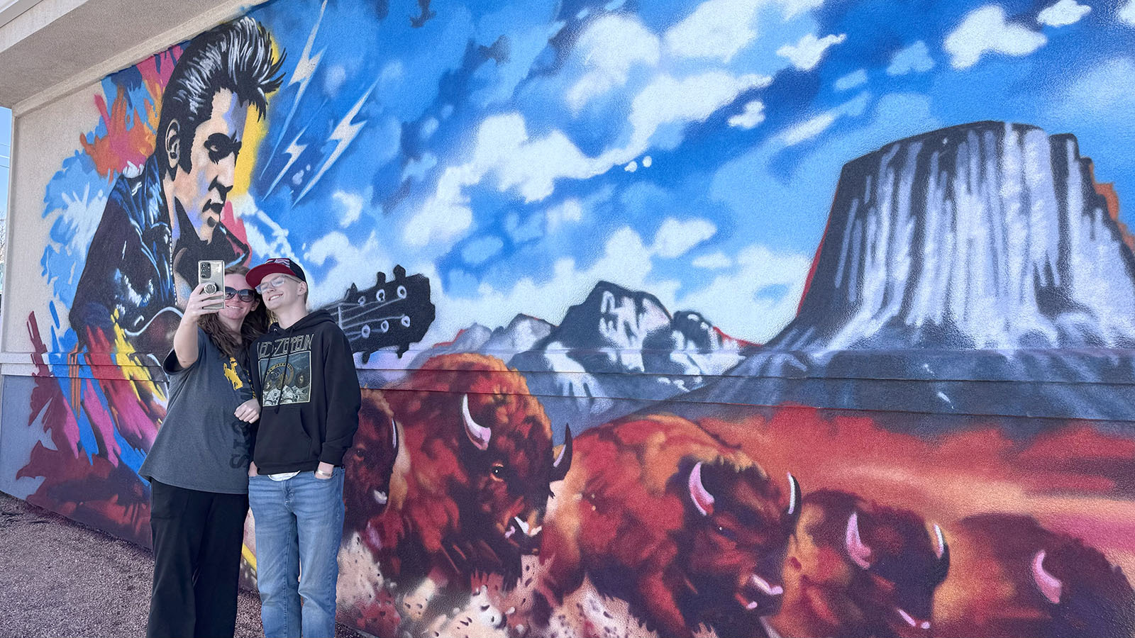 Nearly 50 years after his death, Elvis remains forever 25 and the King of Rock ‘N’ Roll at the corner of East Lincolnway and Campbell Avenue in Cheyenne — despite never performing here. A new mural there features Elvis, stampeding bison and Devils Tower. Here, Molly and Radley Kopp take a selfie with the mural.