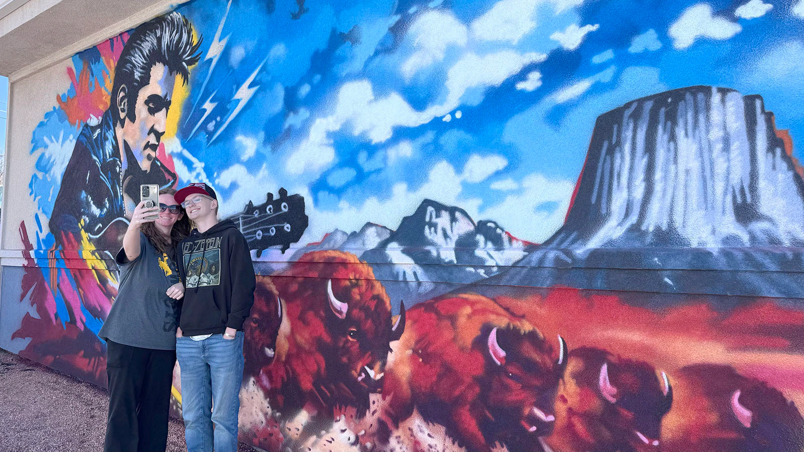 Nearly 50 years after his death, Elvis remains forever 25 and the King of Rock ‘N’ Roll at the corner of East Lincolnway and Campbell Avenue in Cheyenne — despite never performing here. A new mural there features Elvis, stampeding bison and Devils Tower. Here, Molly and Radley Kopp take a selfie with the mural.