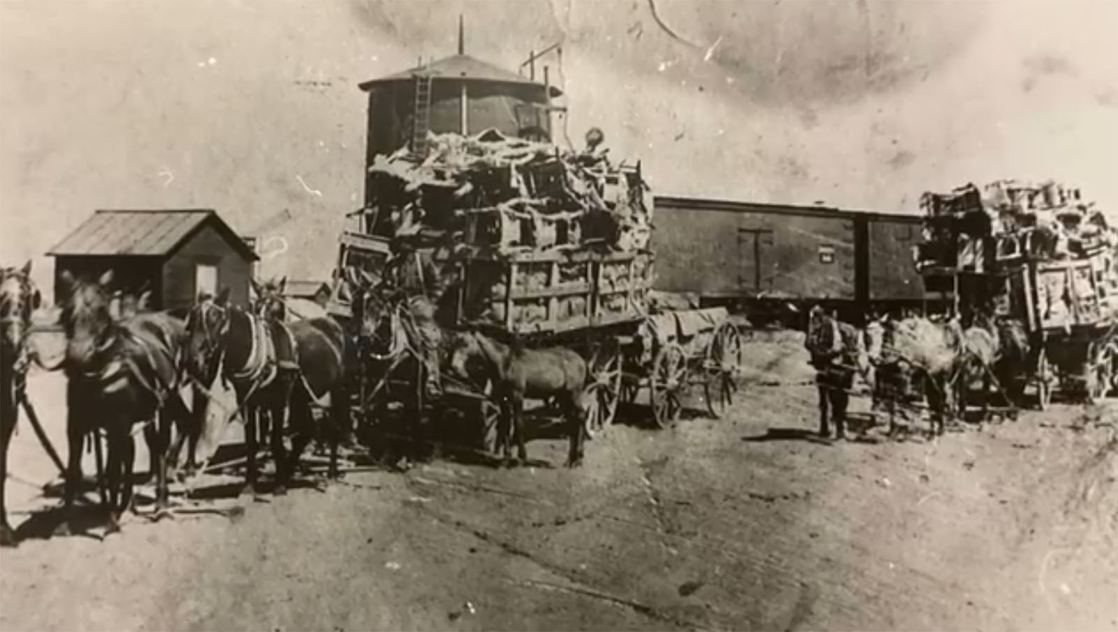 Overloaded wagons pulled by horses take the furnishings of the new Emery Hotel from the train to the hotel in Thermopolis in 1907.