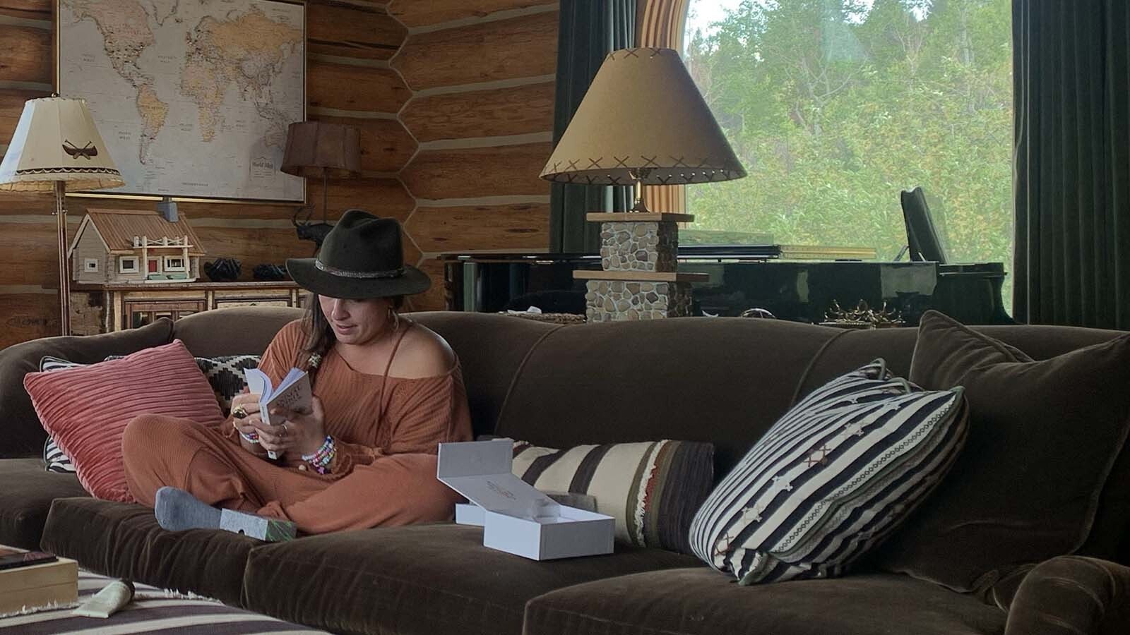 Emily Warren seated on the couch of her cabin in Wilson, Wyoming, while writing "Dont Start Now," which became a smash platinum-selling song for Dua Lipa.
