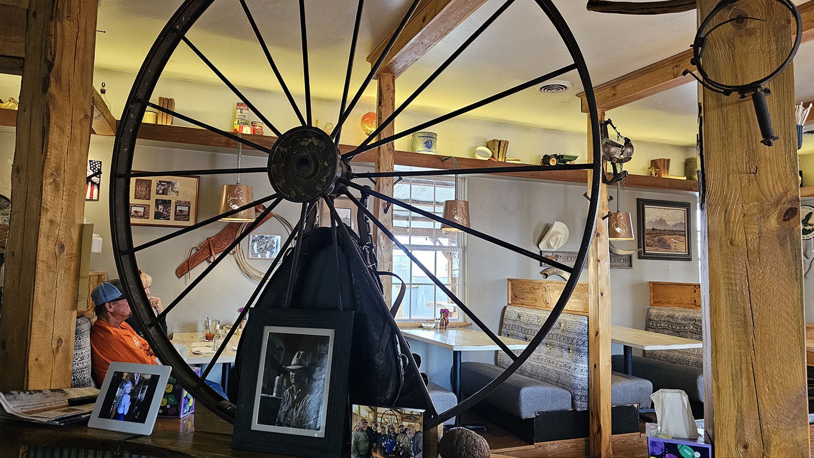 A wagon wheel helps bring definition to the space farming the bar and the dining area.