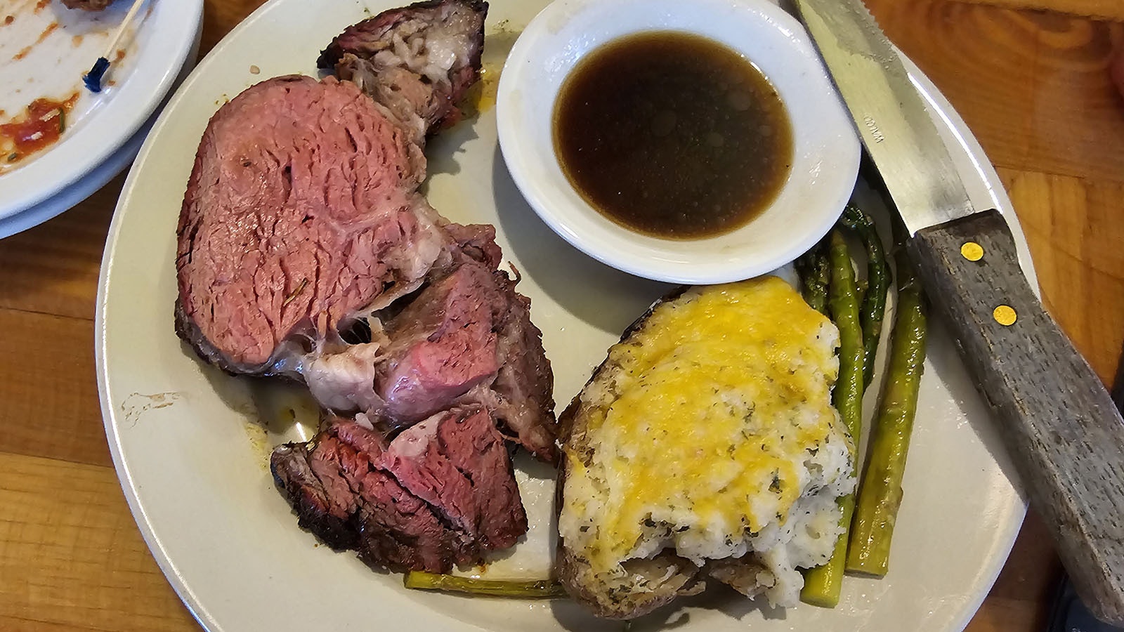 Smoked prime rib dinner with twice-baked potato and asparagus.