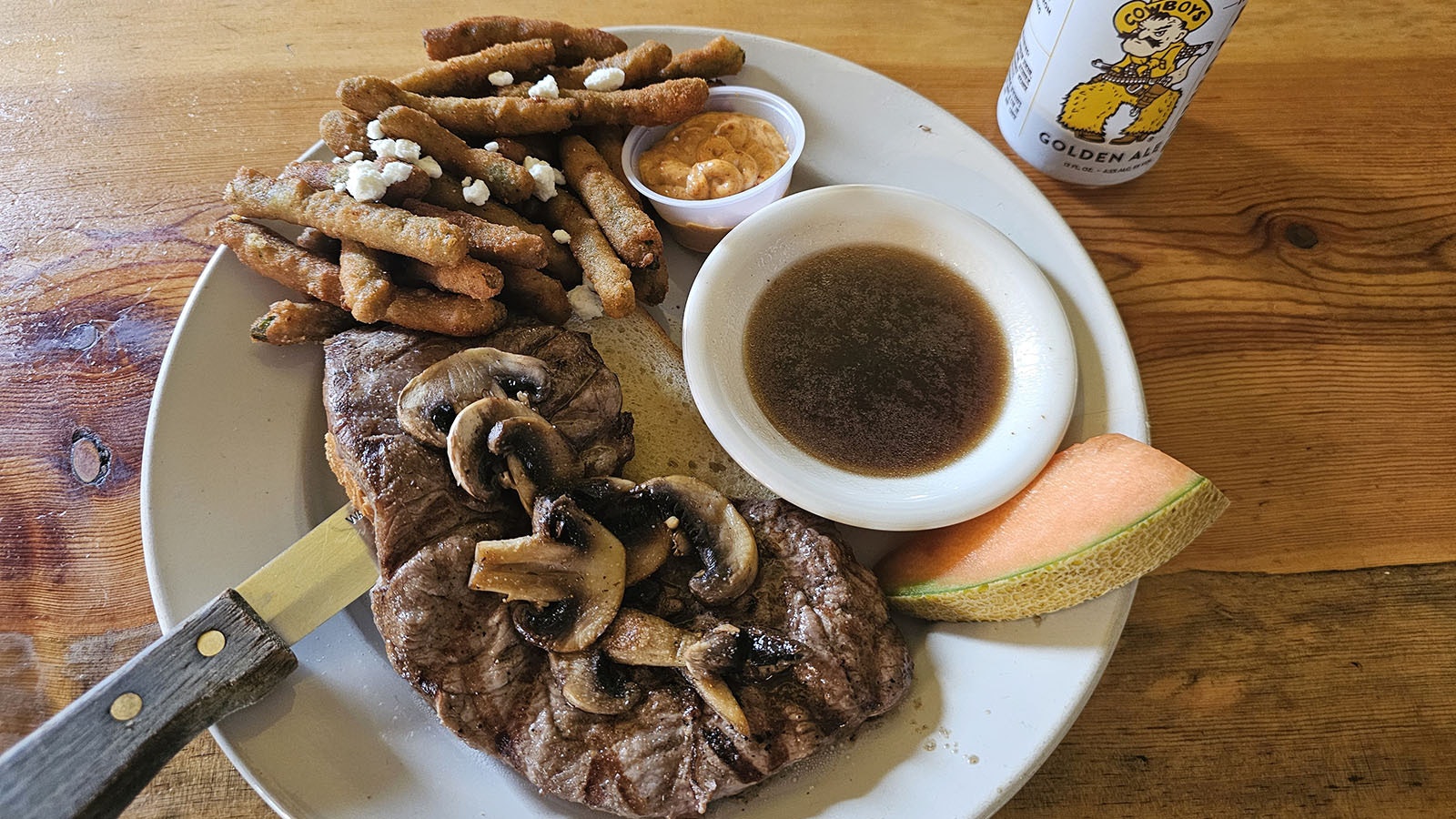 The prime rib steak sandwich at The Emporium, along with a can of Wyoming brewed Cowboy beer.