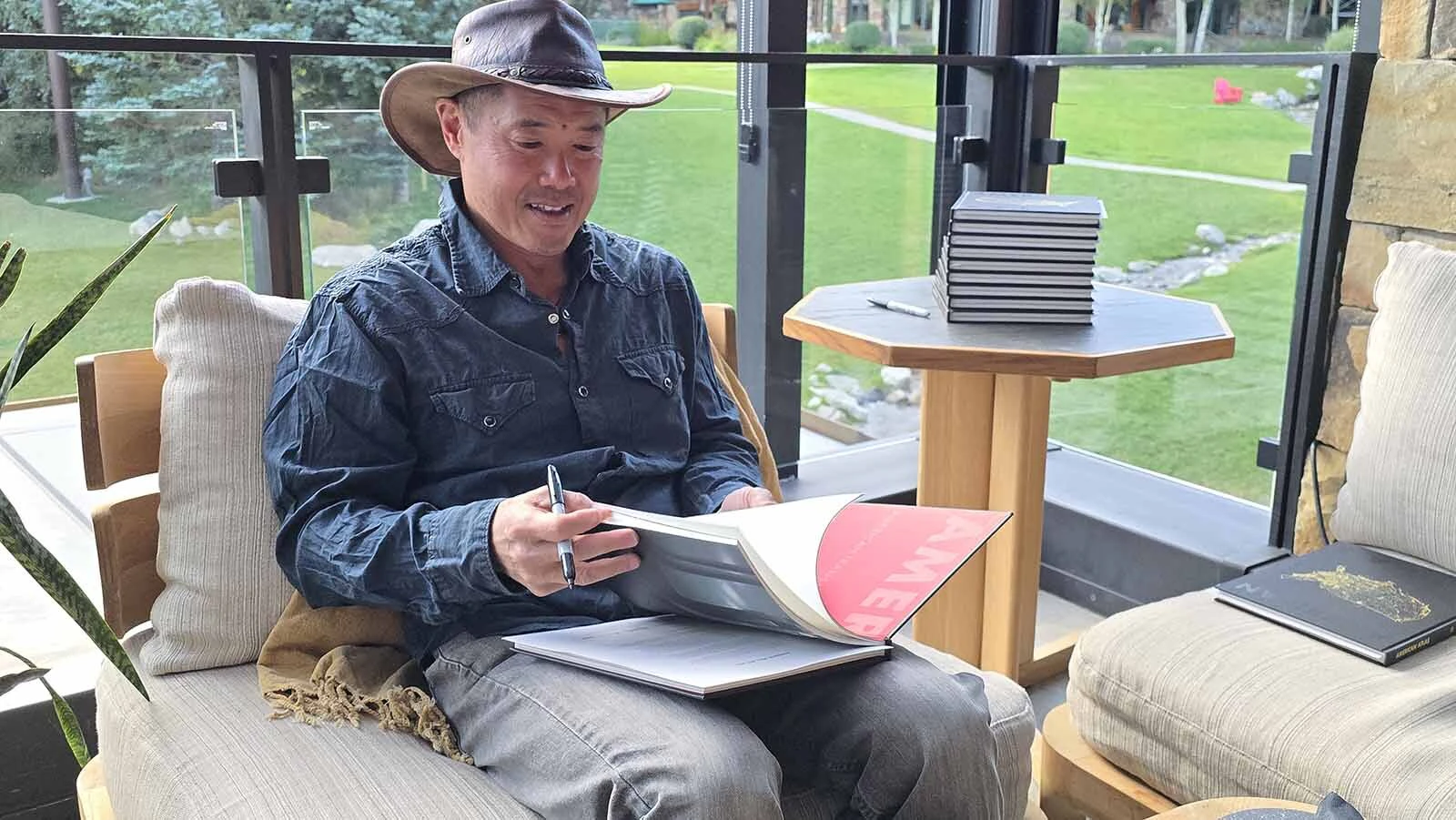 Hut8Corp Founder Bill Tai, and founding investor for companies like Zoom and Canva, signs copies of a book produced by American Transmission Leadership and Security, or Atlas, a group that wants thought leaders across the nation to rethink America’s energy grid.