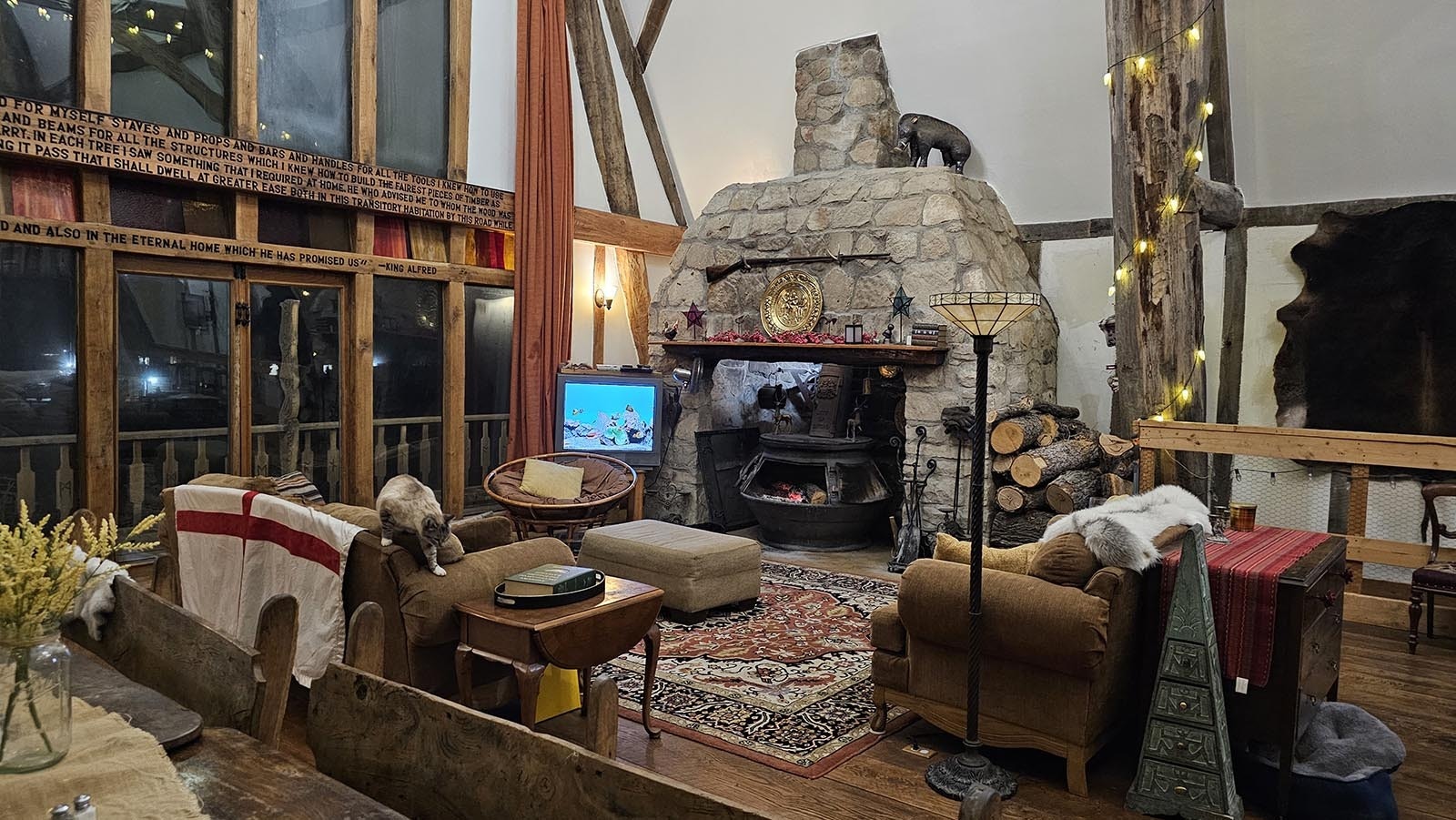 The living room of Cyning Meadowcroft's medieval-style, cruck-constructed home in Happy Valley. Complete with cat.