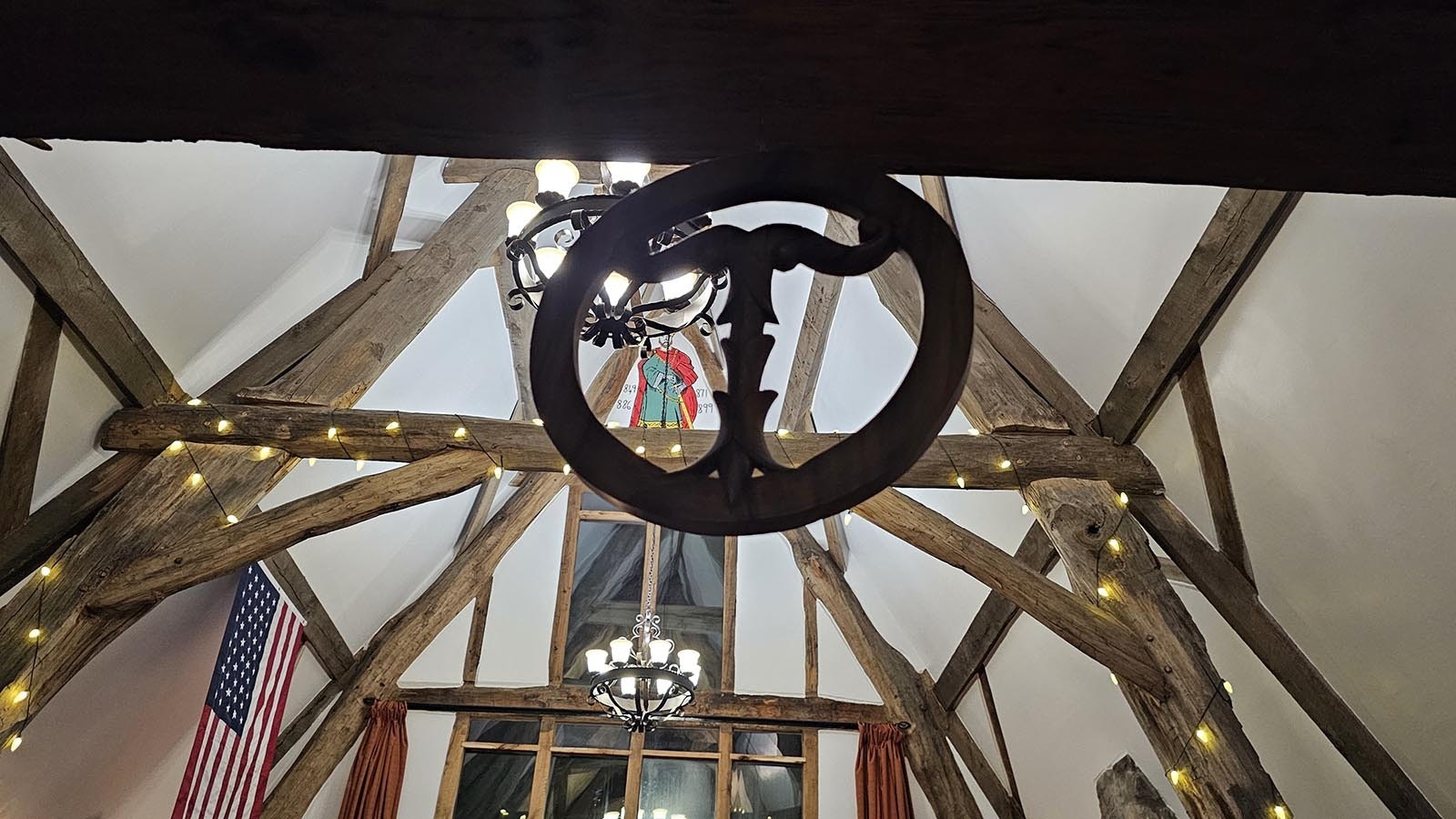 A gift from a sister, this round artwork is made from one piece of wood, and decorates Cyning Meadowcroft's medieval-style, cruck-constructed home in Happy Valley.