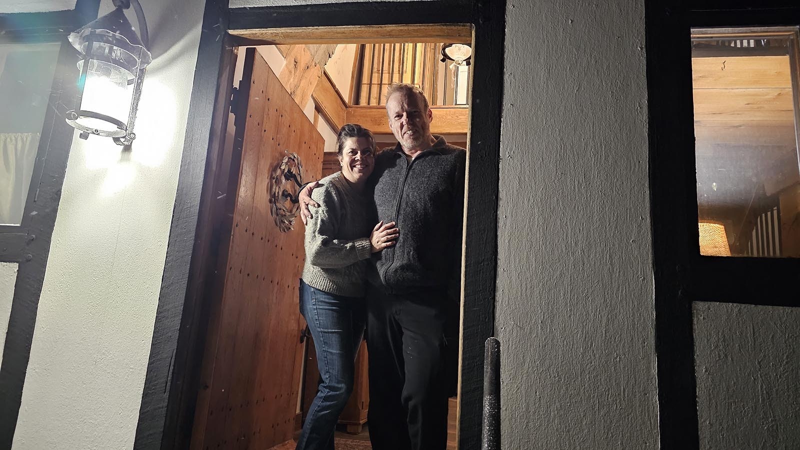 Cyning Meadowcroft with his wife, Christine, at the door of their medieval-style, cruck-constructed home in Happy Valley.