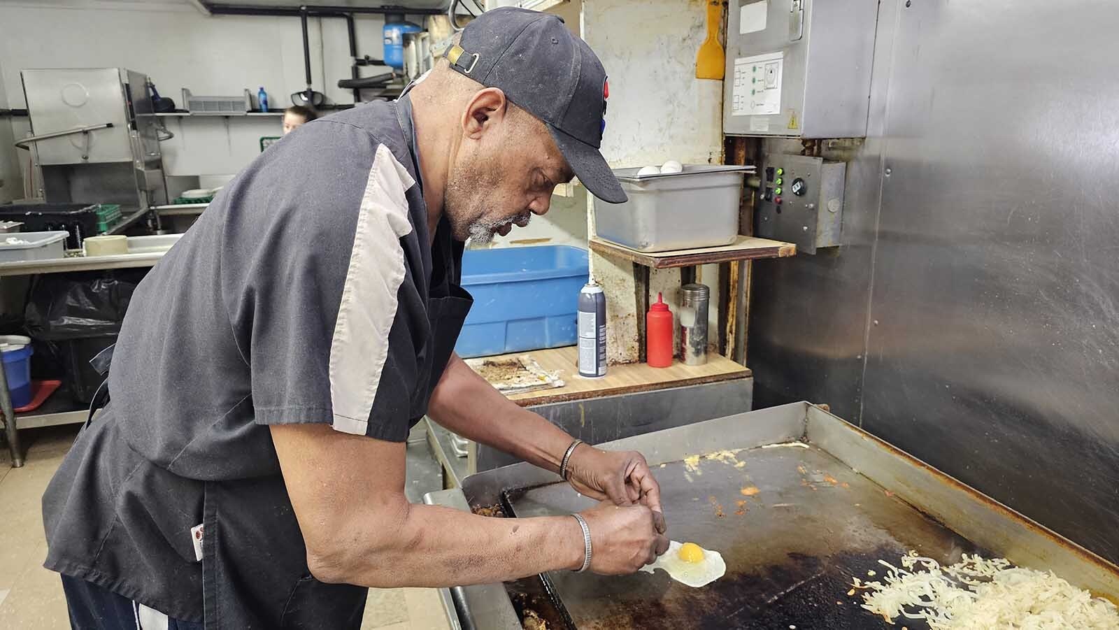 Willie Banks preparfes eggs on the grill at Diamond Horseshoe Cafe in Cheyenne.