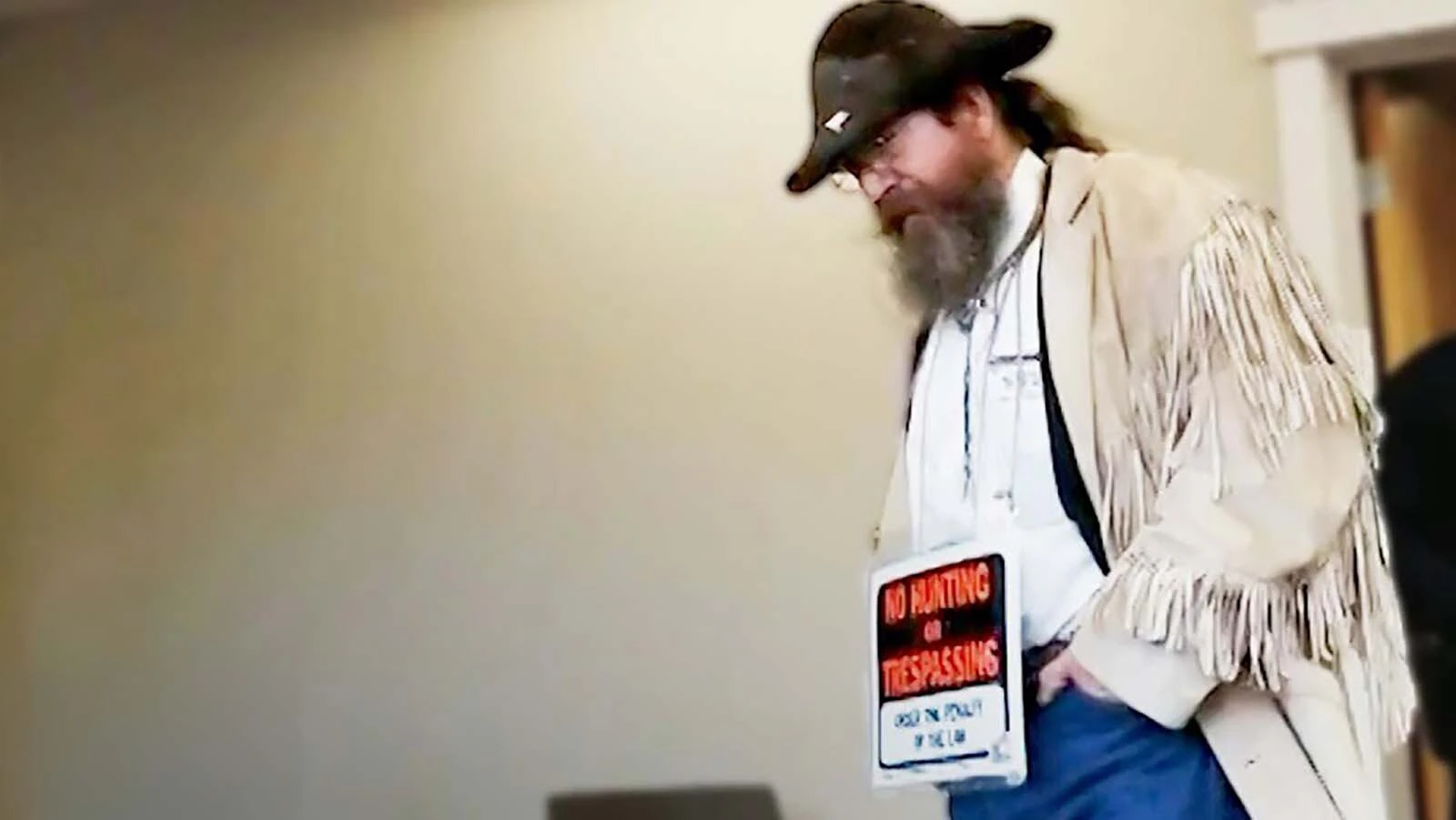 Ernie Tertelgte of Montana made headlines when he wore a "No Hunting No Trespassing" sign to court.