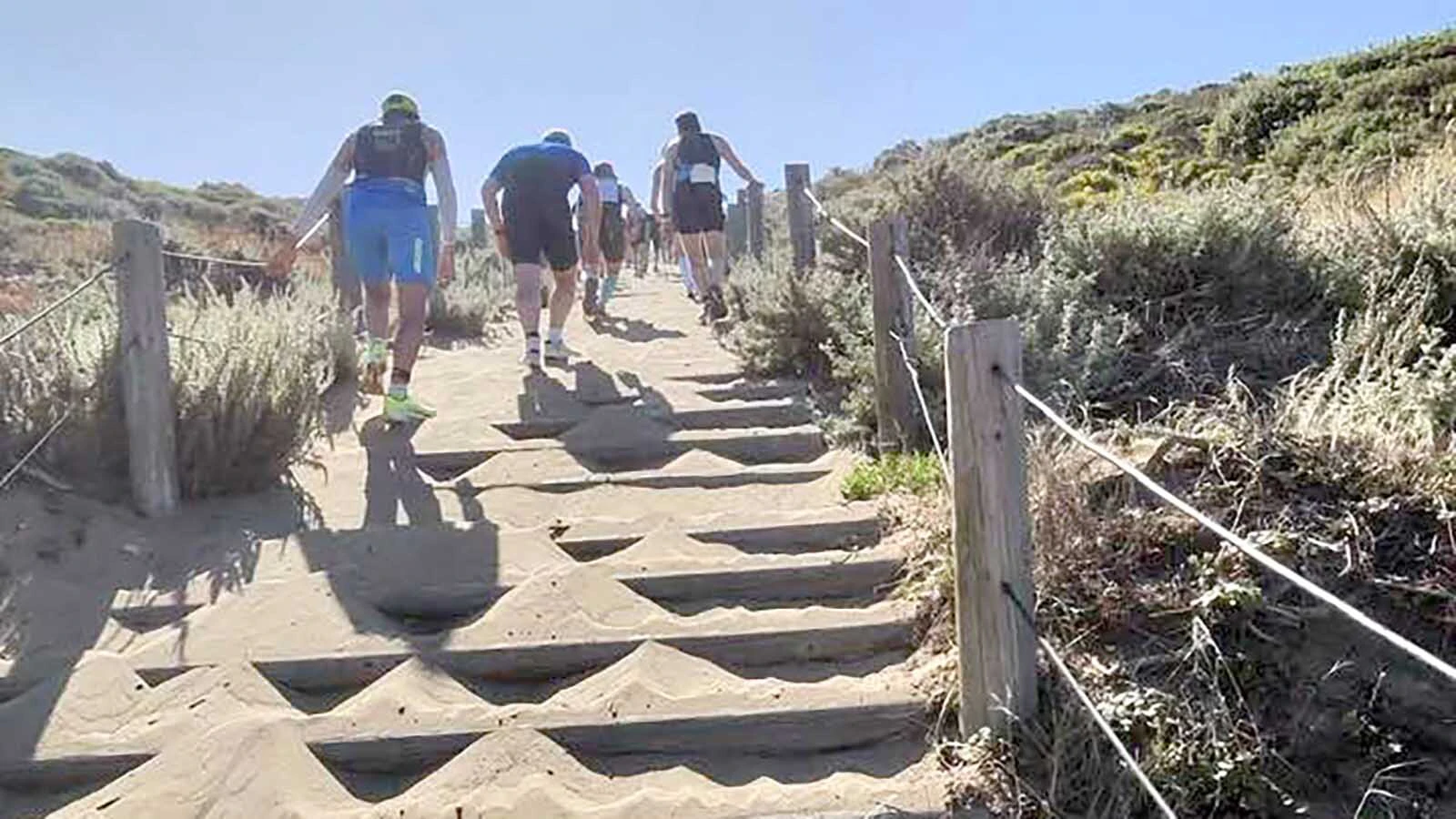 The infamous sand stairs on the course burn participants’ leg muscles.