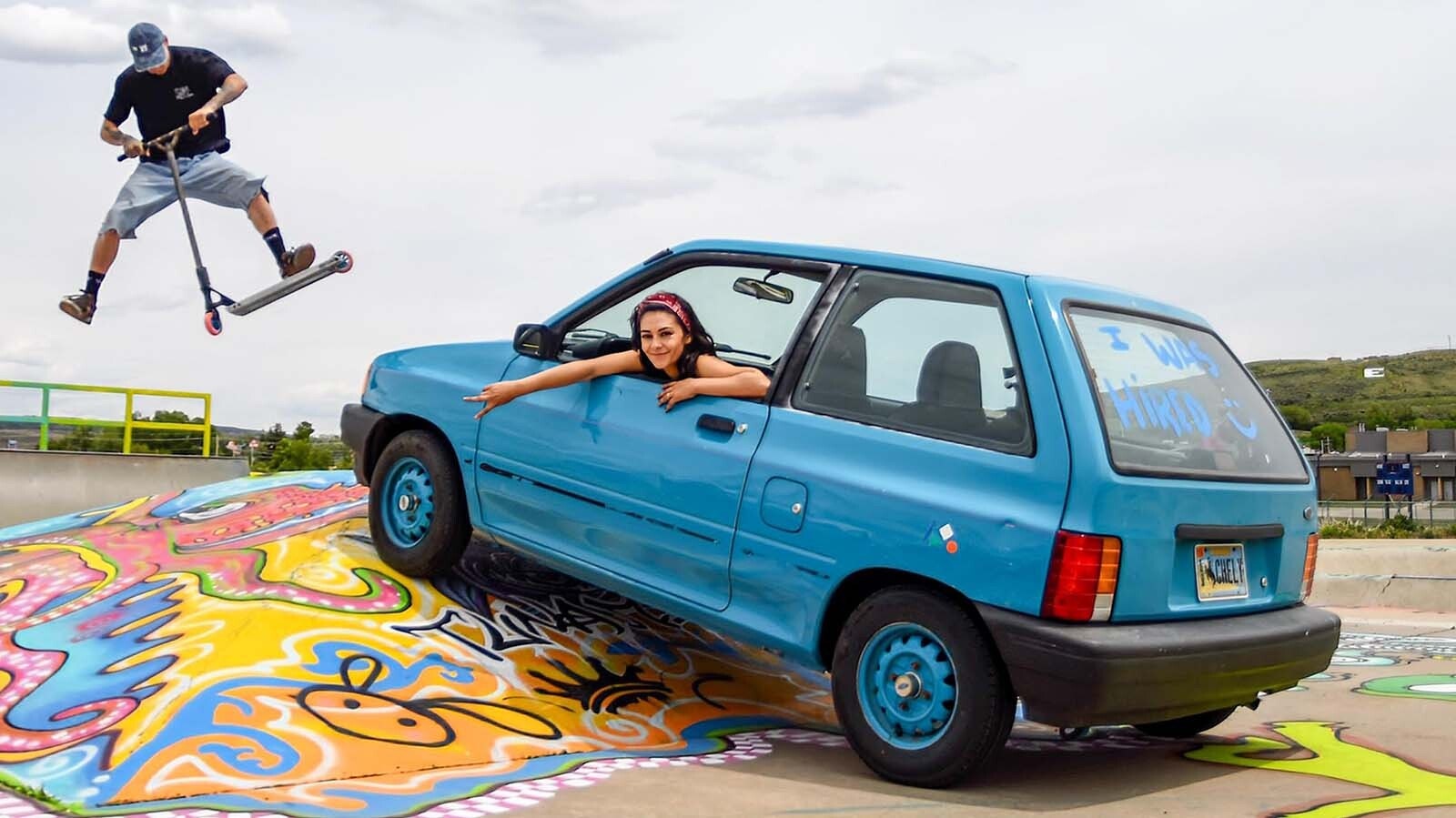 Evanston artist Michelle ‘Chely’ Gomez is all smiles as she shows off her work at the Evanston Skate Park. Local skate and scooter instructor Cutter Nicholson is in the background.