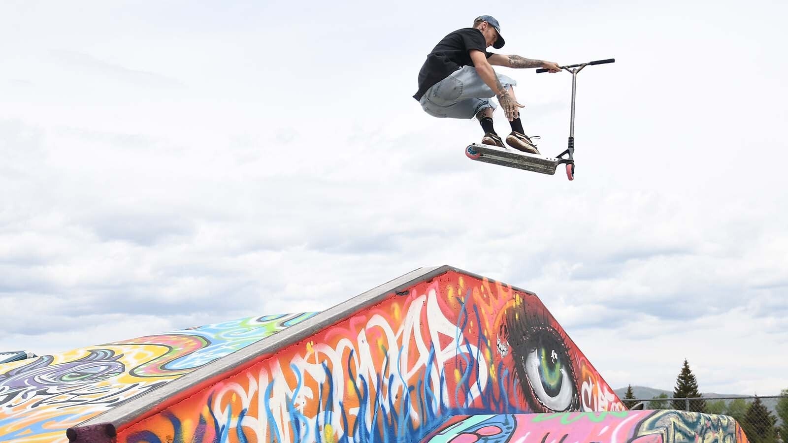 Scooter enthusiast Cutter Nicholson grabs some air off the newly-painted ramp at the Evanston Skate Park.