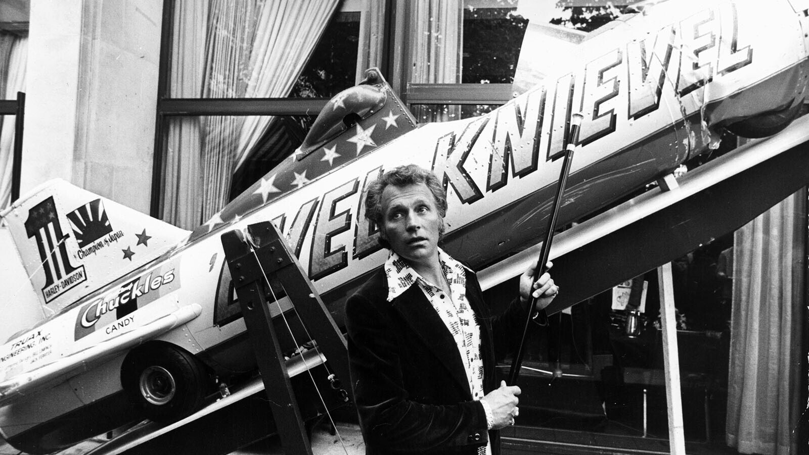 Evel Knievel with the Sky-Cycle X-2 rocket after he failed to clear the Snake River Canyon in it. He used the beat-up rocket to promote his next stunt — jumping 13 buses at Wembley Stadium in England.