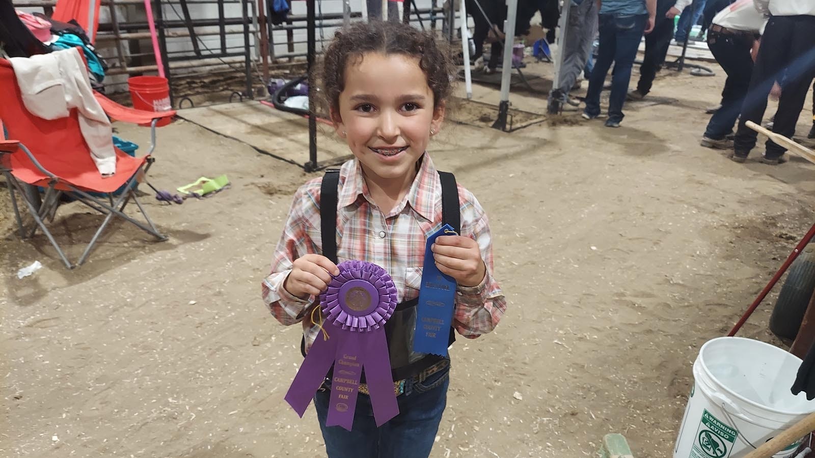 Morgan Elkins poses with her ribbons after taking first place and Grand Champion Junior Showman in the beef show Saturday.