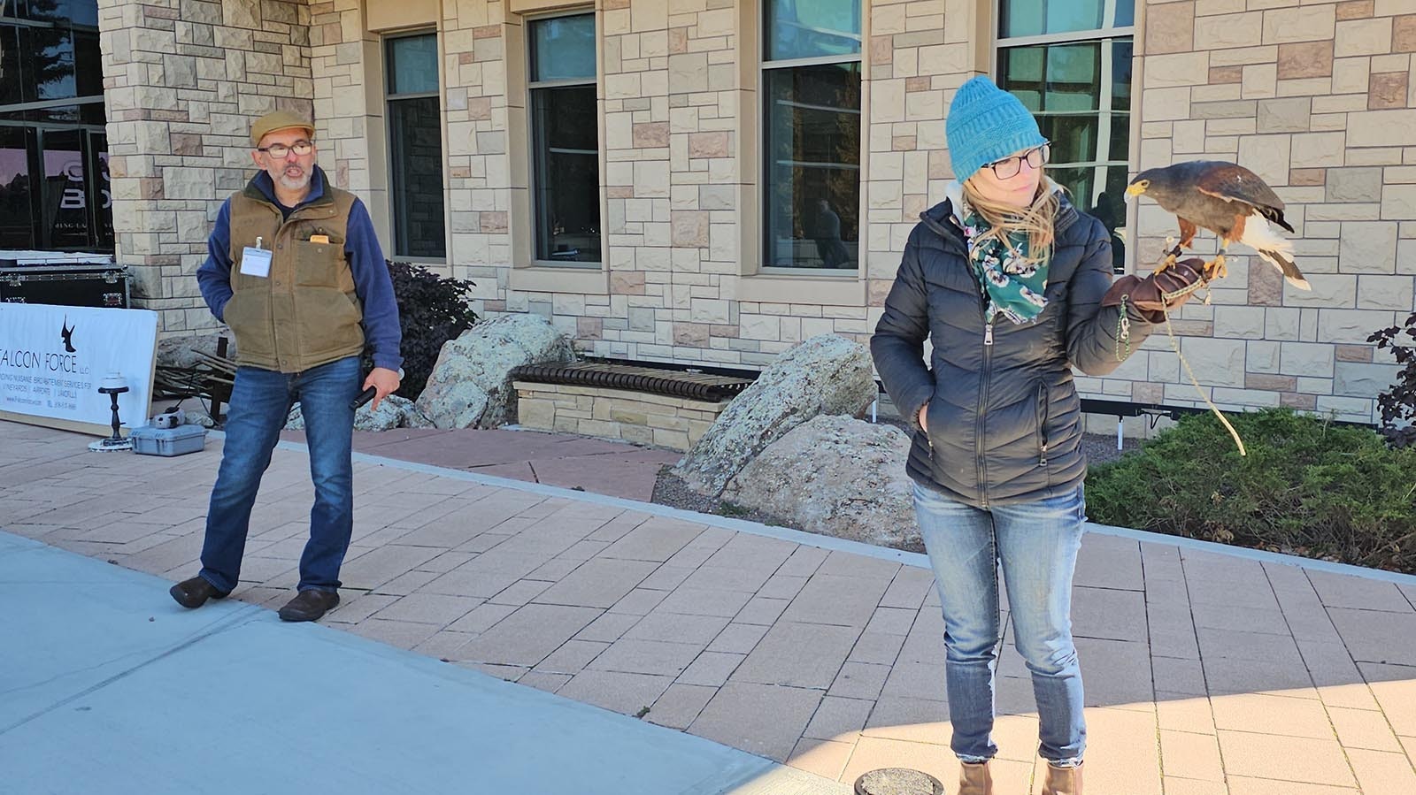 Kyna Sturges holds up a falcon while Vahé Alaverdian talks about its hunting abilities and its lifestyle habits.