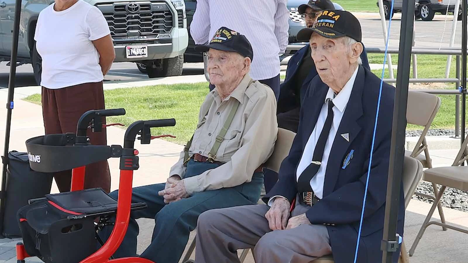 World War II veteran William McMillan, left, and Korean War veteran Cecil Barnes were on hand to help unveil the sculpture, titled "Fallen Comrade."