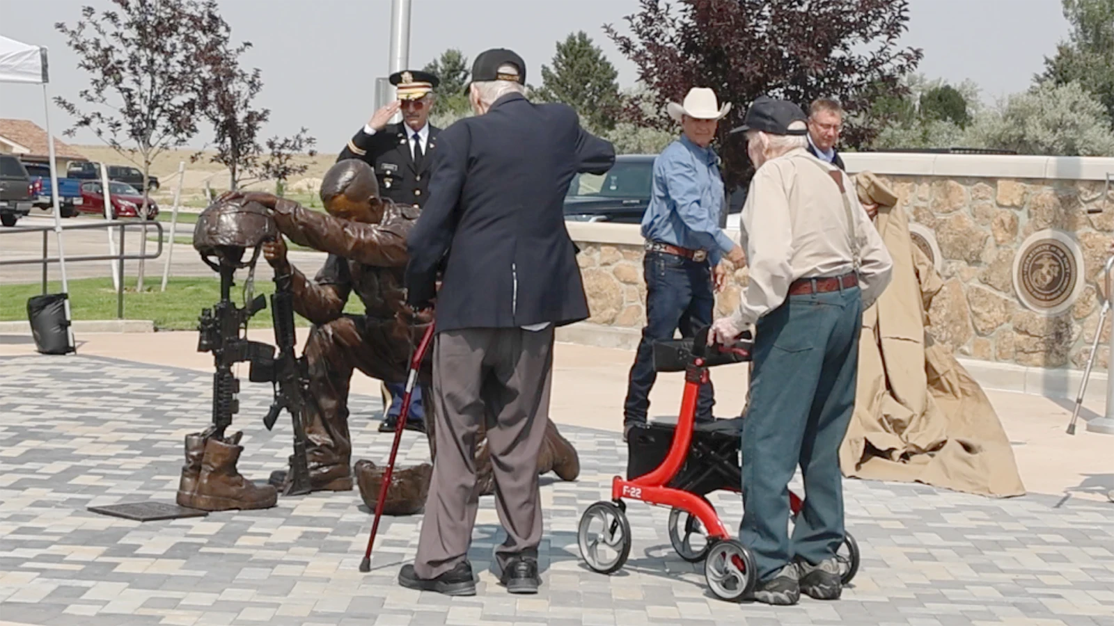 Herb Navarro and Cecil Barnes salute the statue as it is unveiled.