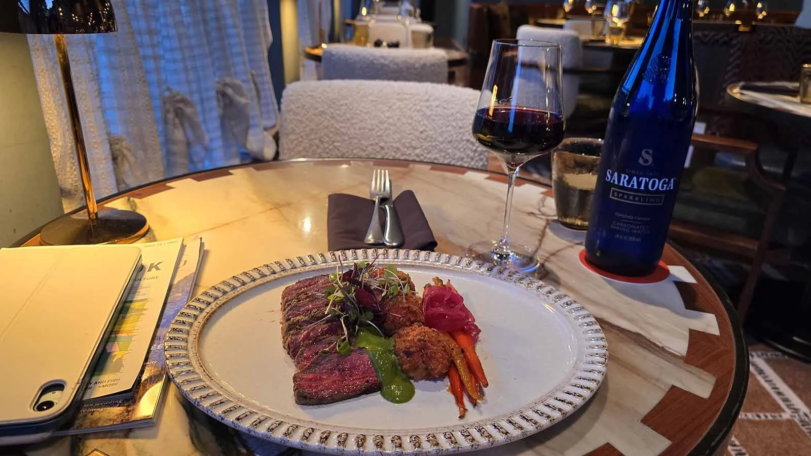Steak with blue cheese potato puffs and roasted carrots paired with wine at Sure Hand, Faraway Jackson Hole’s all-day restaurant.