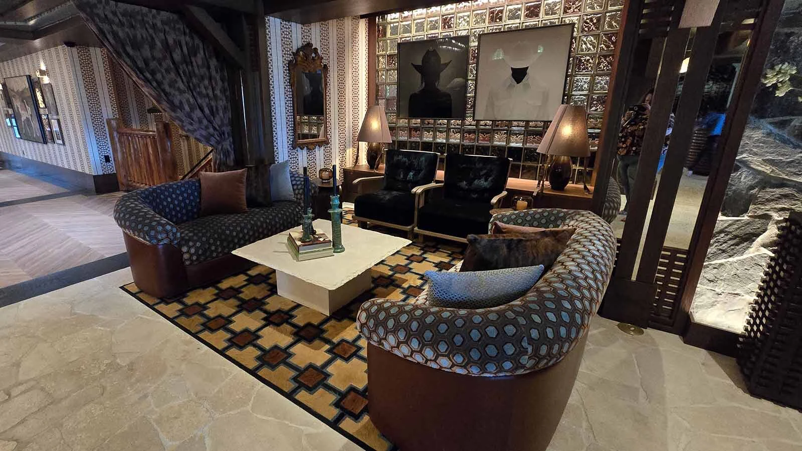 Another comfortable seating area, decorated with portraits of a cowgirl and a cowboy at Faraway Jackson Hole.
