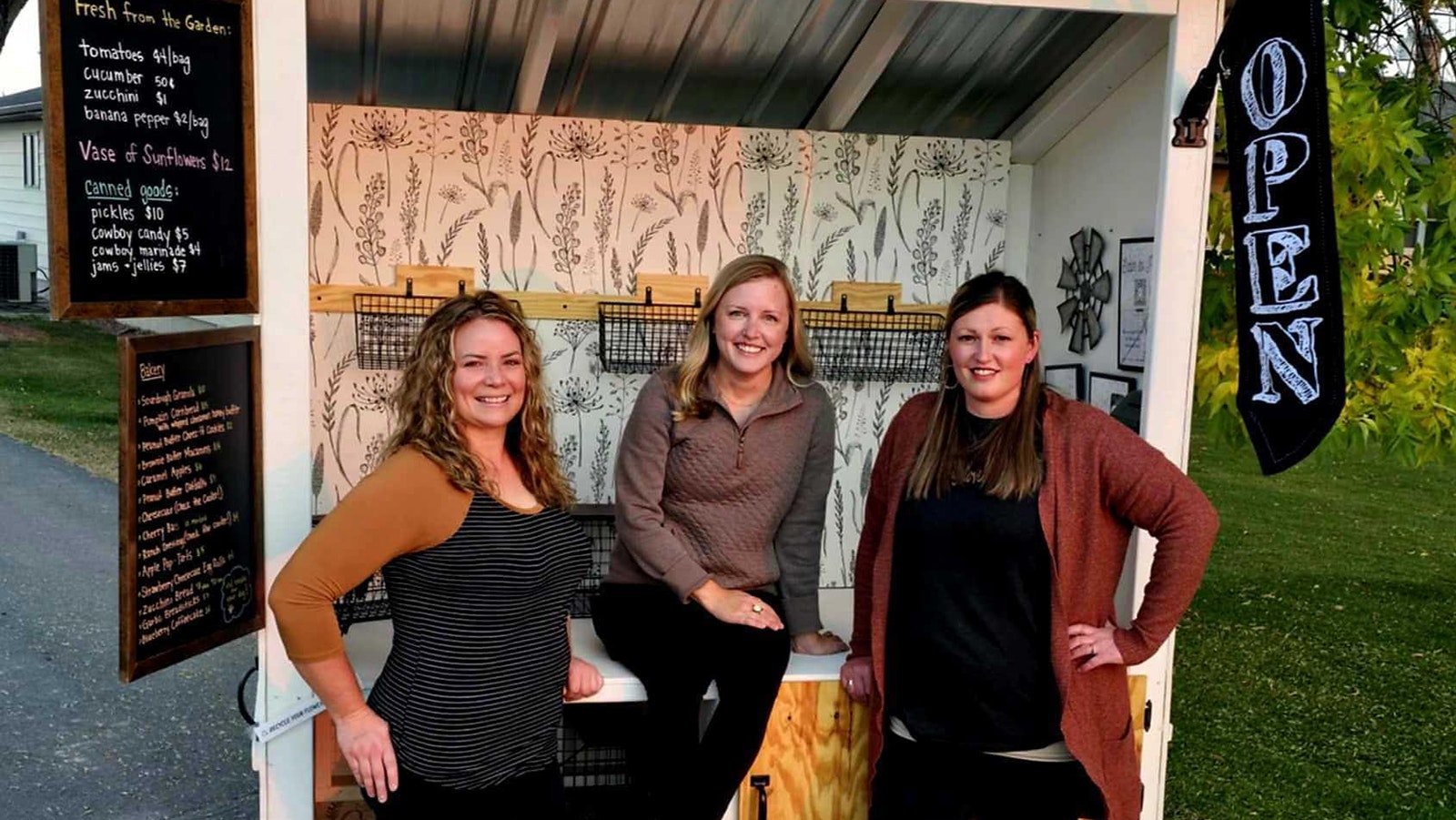 Kristen Scheuerman, from left, Alex Hardy and Tabby Scheuerman started the Road 12 Farm Stand last year in Worland. The stand offers flowers, produce and baked goods.