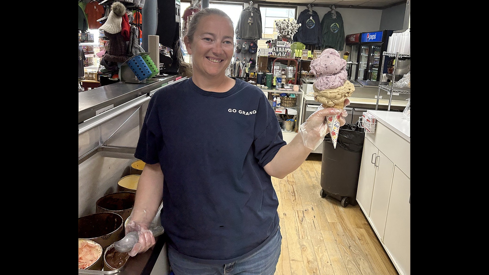Katie Sims works at the Farson Mercantile. She's holding the store's signature Big Cone, with costs $10 and has nearly a half-gallon of ice cream.