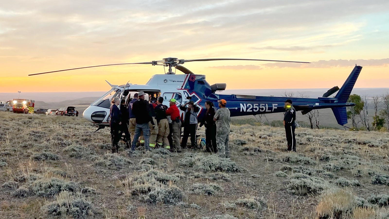 Emergency responders load a boy onto a medical helicopter early Tuesday morning after he was stranded in the Wyoming wilderness overnight with his father when their truck went off the road.
