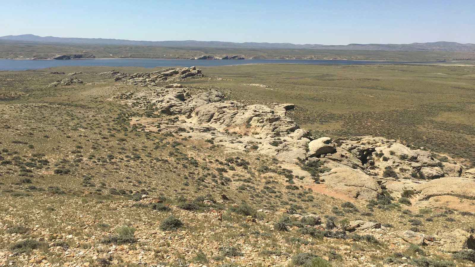 Outcrops of the Ferris Formation near Seminoe Reservoir in Carbon County. These rocks preserve fossil fragments of dinosaurs, crocodiles, turtles, snakes, and other animals that lived in the "latest Cretaceous" of Wyoming, no more than one million years before the Cretaceous-Paleogene extinction event that killed 75% of life on Earth.