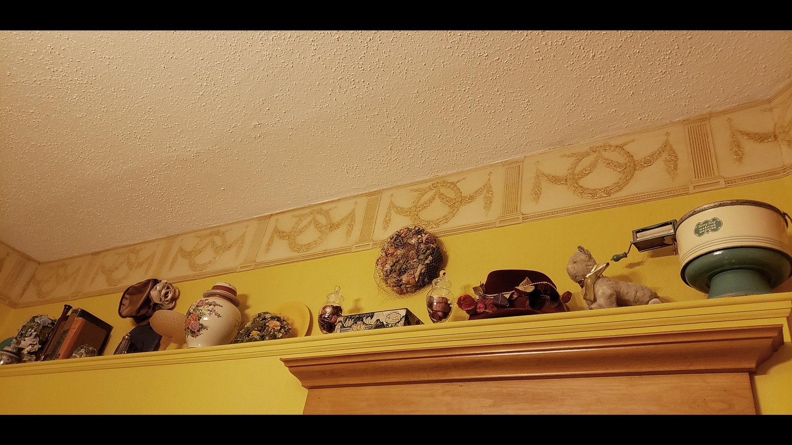 An eclectic mix of nostalgic decorations line a shelf in the Gold Room at the Ferris Mansion.