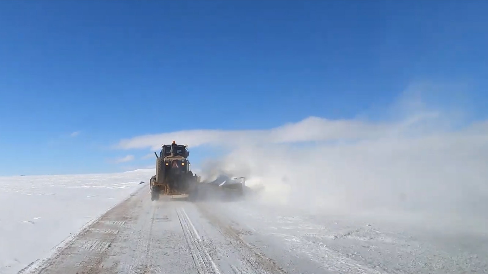 In the "Little Siberia" region of northern Albany County, Wyoming, snowplowing is done by committee, one truck after the other.