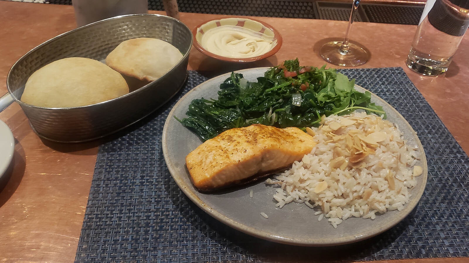 Salmon with greens and rice pilaf as well as delicious balloon bread and hummus.