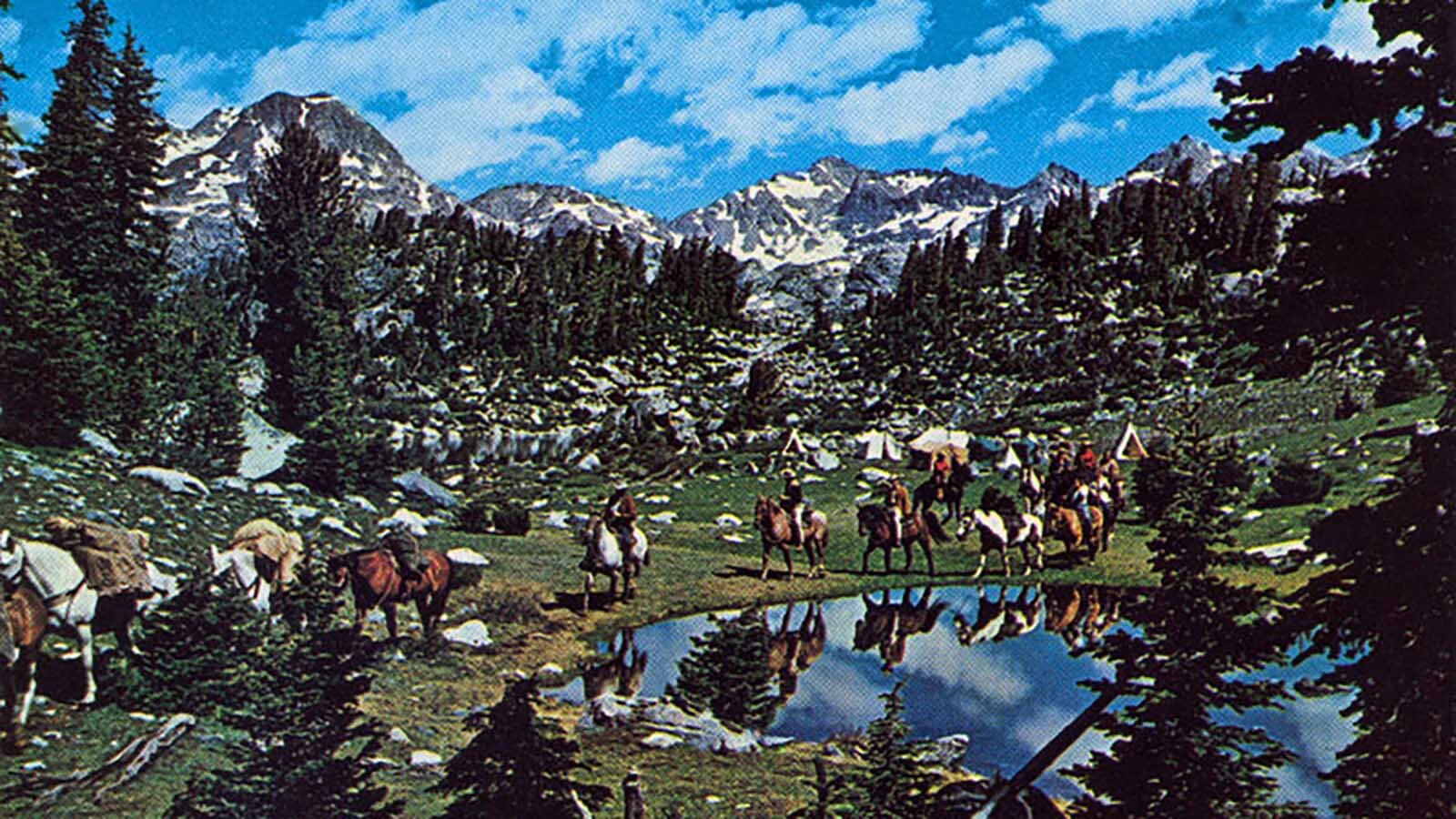 A postcard of a photo taken of a Finish Mitchell packing trip in the Wind River Mountains of Wyoming.