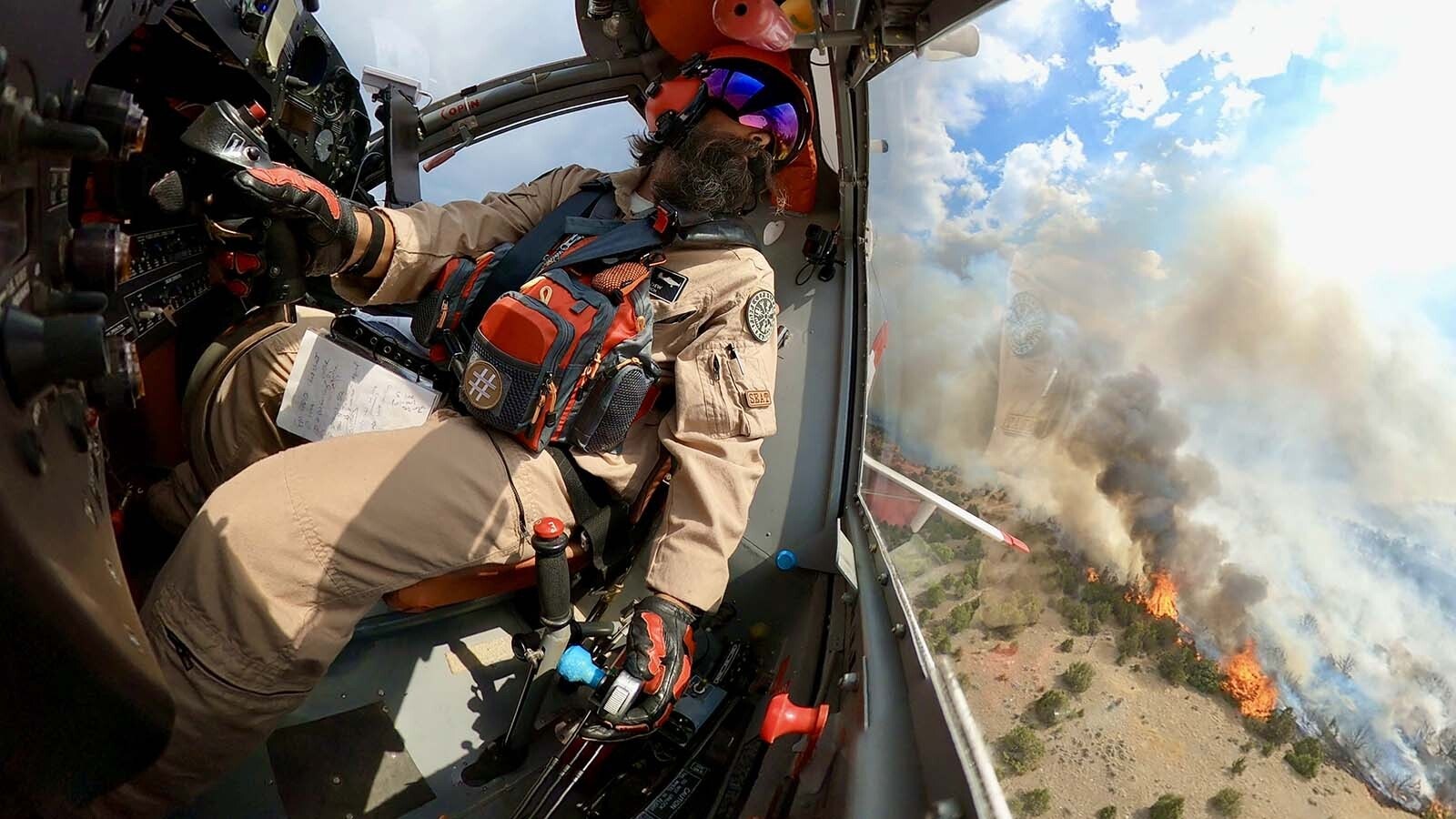 Pilot Nick Dew drops a load of retardant on a wildfire in Wyoming from his Tanker 837.