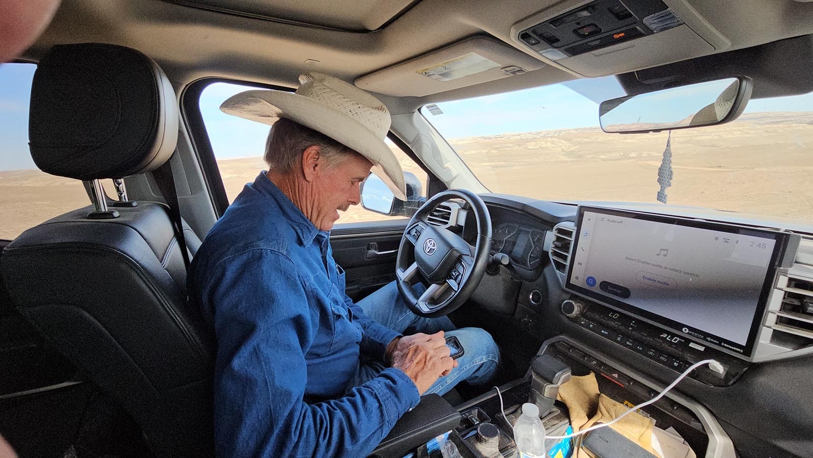 David Belus looks at photos he took of the devastation on his ranch, days after nearly 50,000 acres went up in smoke. The photos include dead cattle, as well as yearlings who were so burned they had to be euthanized.