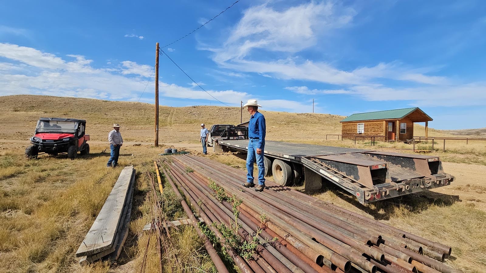 David Belus stands on top of some pipe he acquired to replace some of his fencing that was burned up. Metal doesn't burn, Belus said, so he plans to put in more metal fencing.