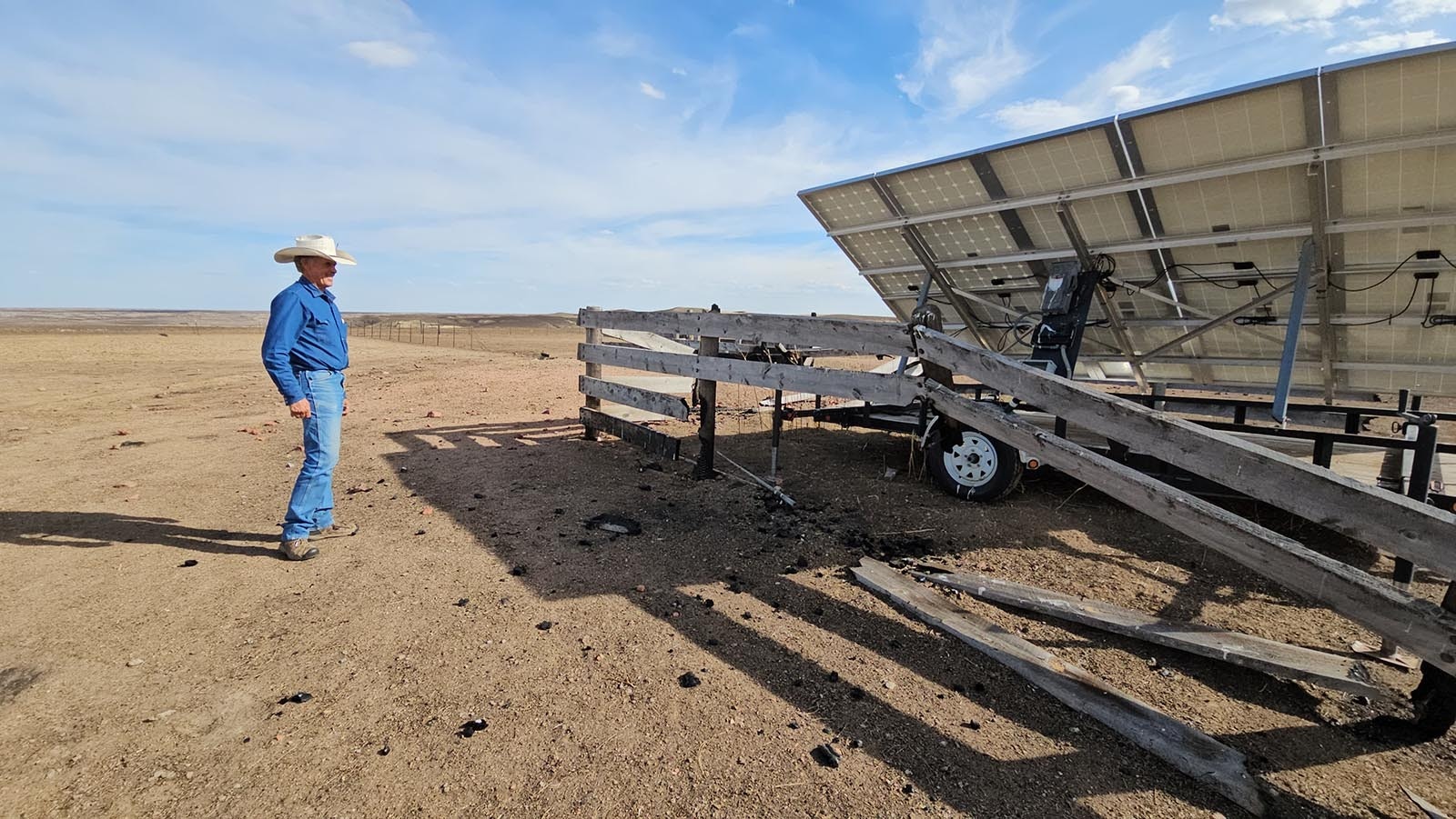 The solar panel that helps power a pump to water cattle is OK, even though fire burned down some parts of the fence around it.