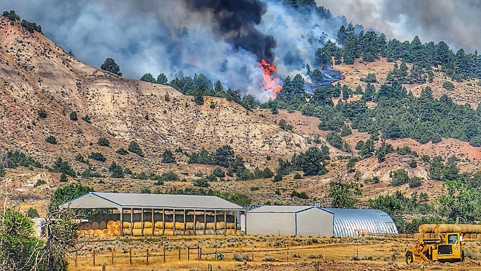 Wildfire threatens a hay barn in Campbell County.