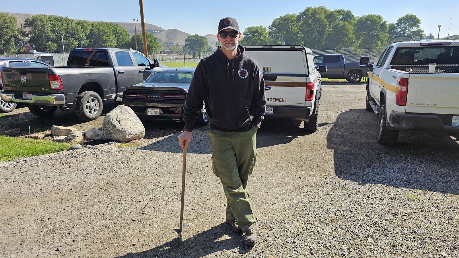 Andy James leans on his Pulaski in more ways than one. It's great for chopping wood or digging in the dirt. It's also a great reminder of the Big Burn in Idaho in 1910 — a cautionary tale for any firefighter who fights wildfire.