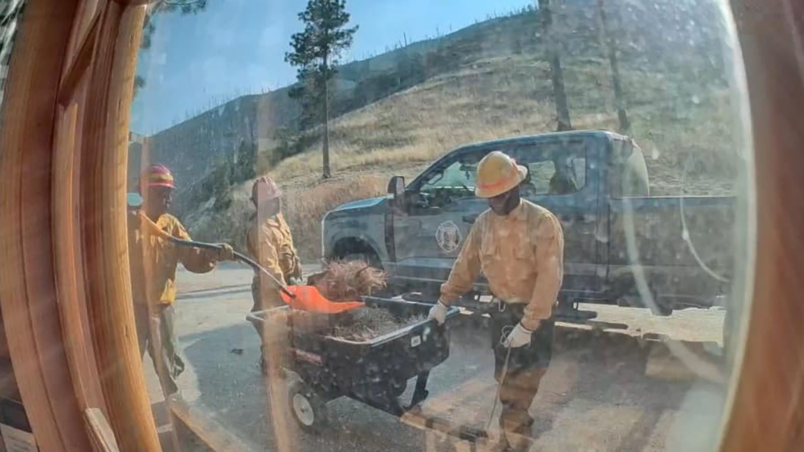 Firefighters working on fire protection for a home in the Red Grade Road area, as seen from a homeowner's exterior camera.