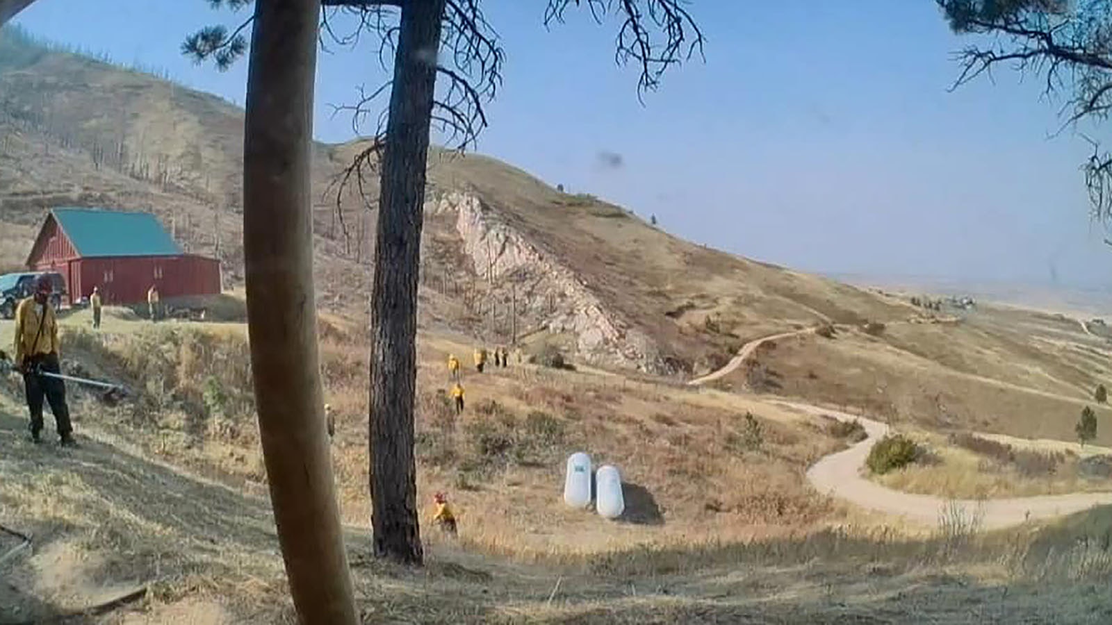 Firefighters working on fire protection for a home in the Red Grade Road area, as seen from a homeowner's exterior camera.